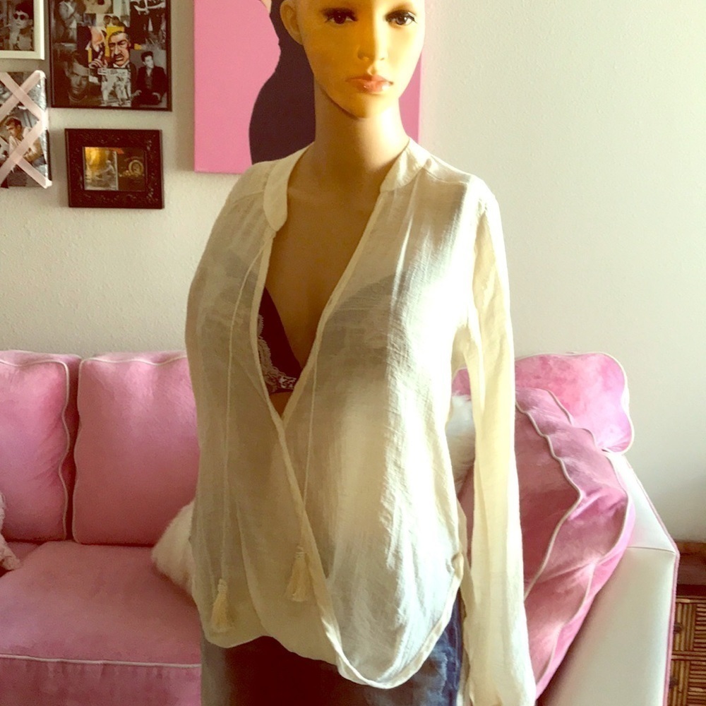 High-Low Boho chic top with tassel tie accent.